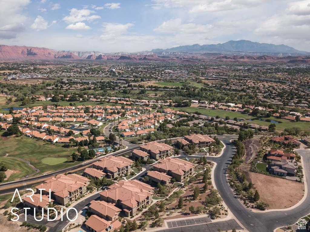 Aerial view of property and surrounding area with mountains and nearby suburban area