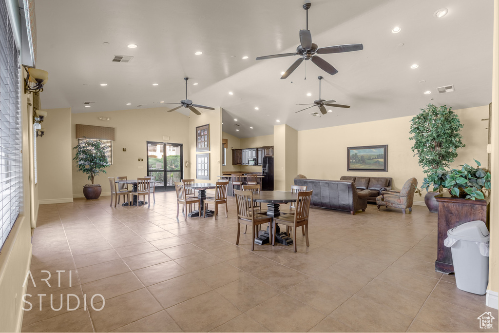 Dining room with a ceiling fan, light tile patterned floors, recessed lighting, and high vaulted ceiling