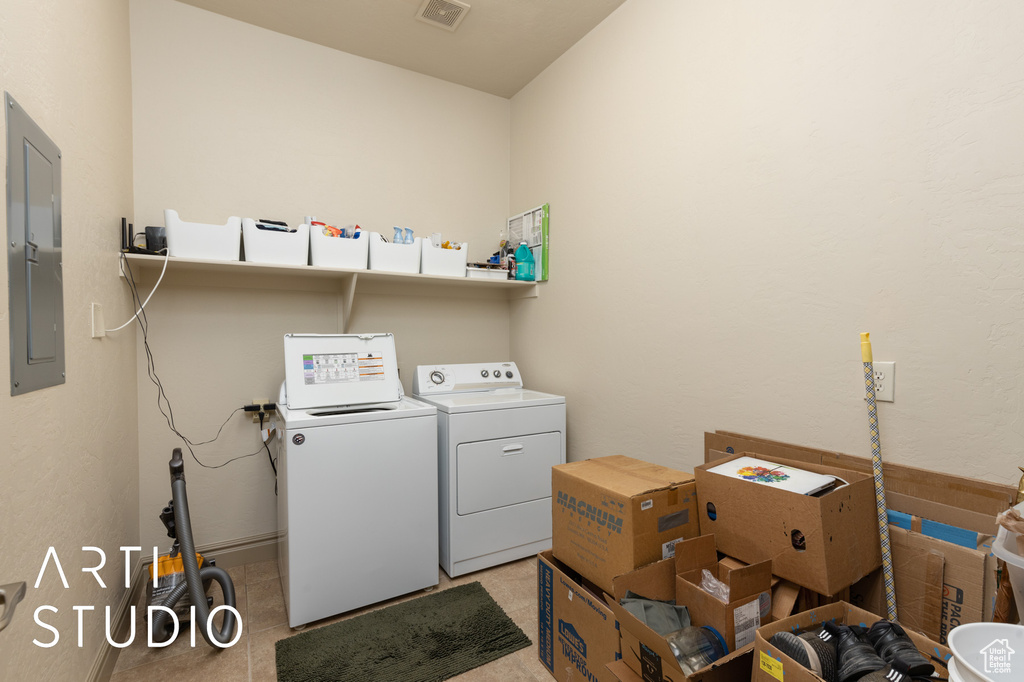 Laundry area featuring independent washer and dryer and electric panel
