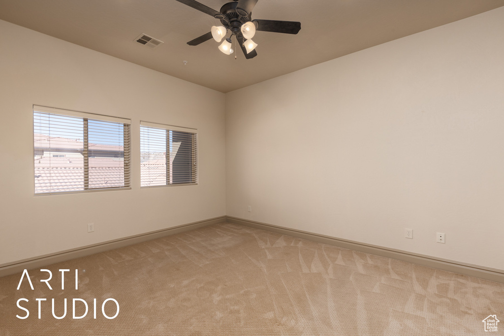 Empty room with light carpet, baseboards, and ceiling fan