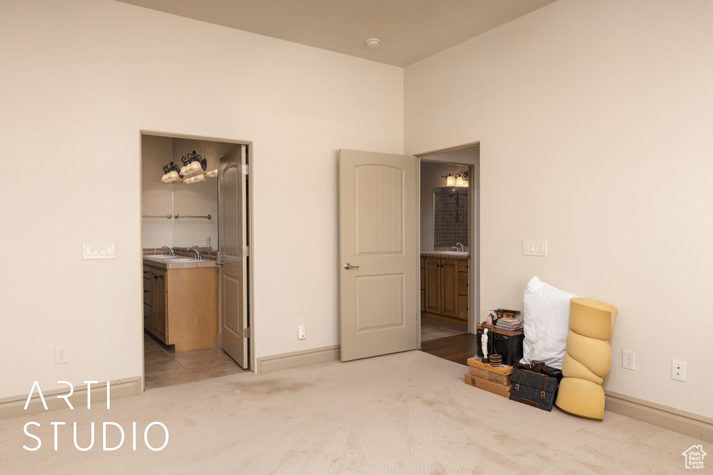 Bedroom with light carpet, baseboards, and a spacious closet