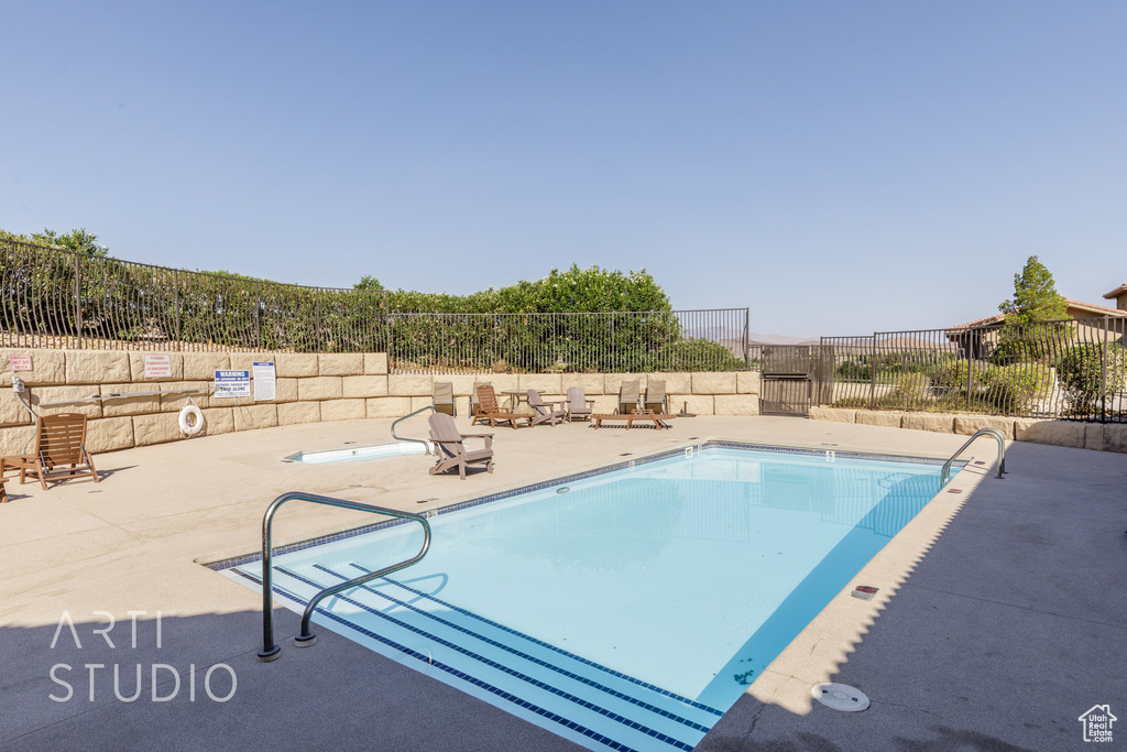 Community pool featuring a patio