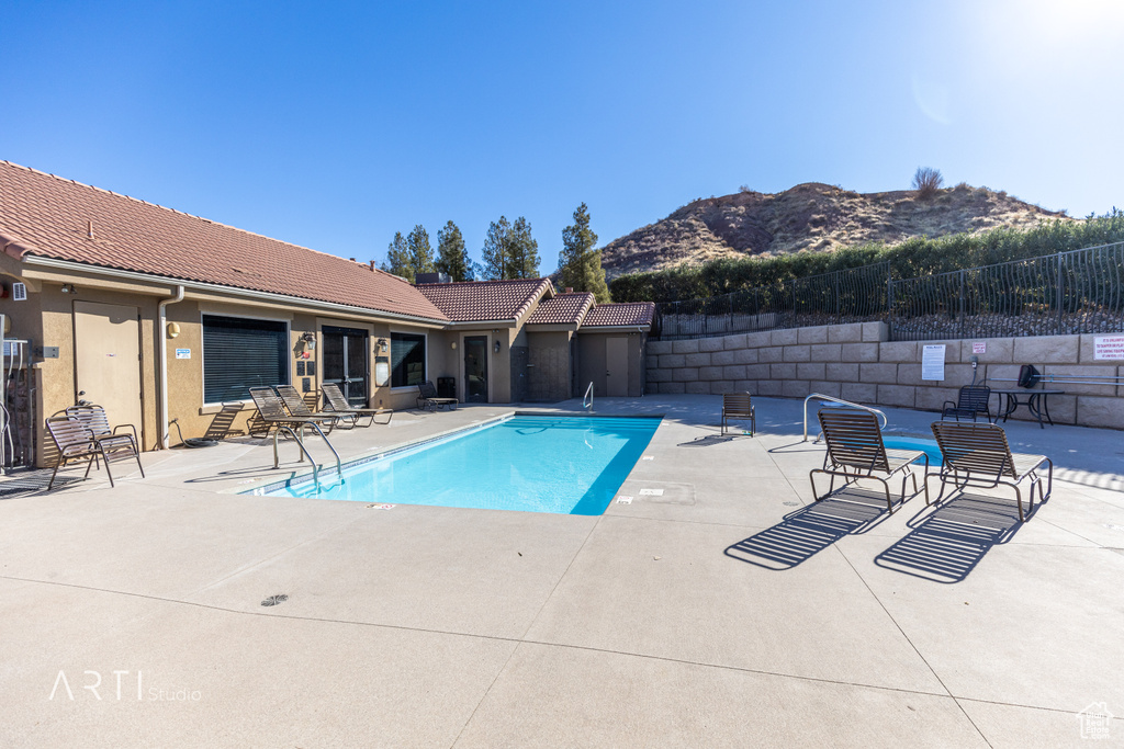 Community pool with a mountain view and a patio