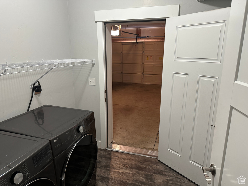 Laundry room featuring washing machine and dryer and dark wood finished floors