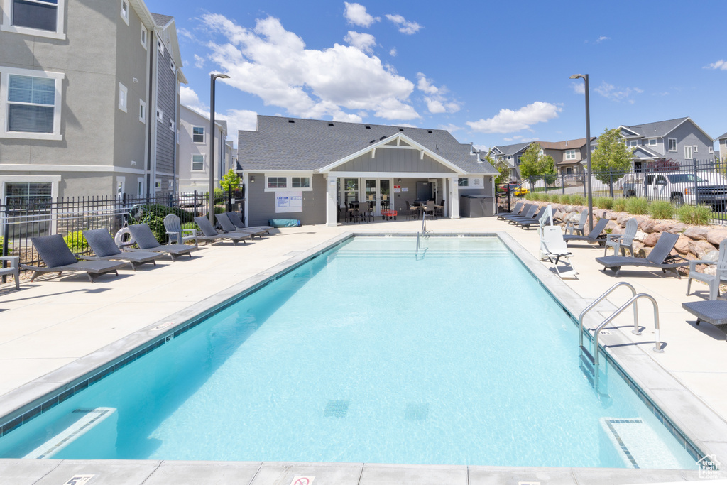 Community pool with a residential view and a patio