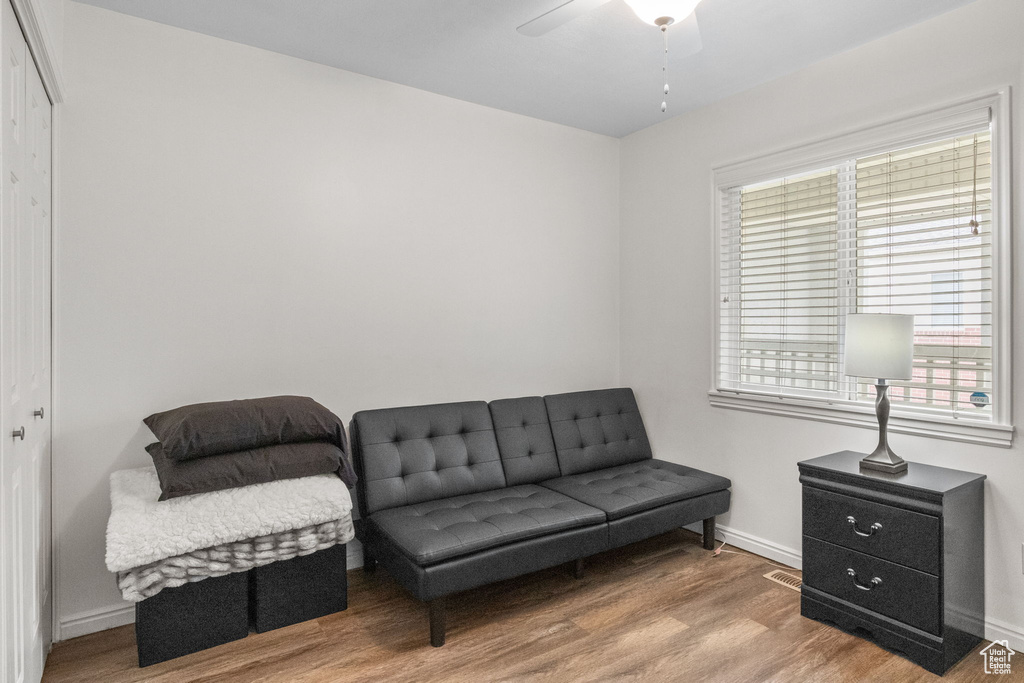 Sitting room featuring ceiling fan, wood finished floors, and baseboards