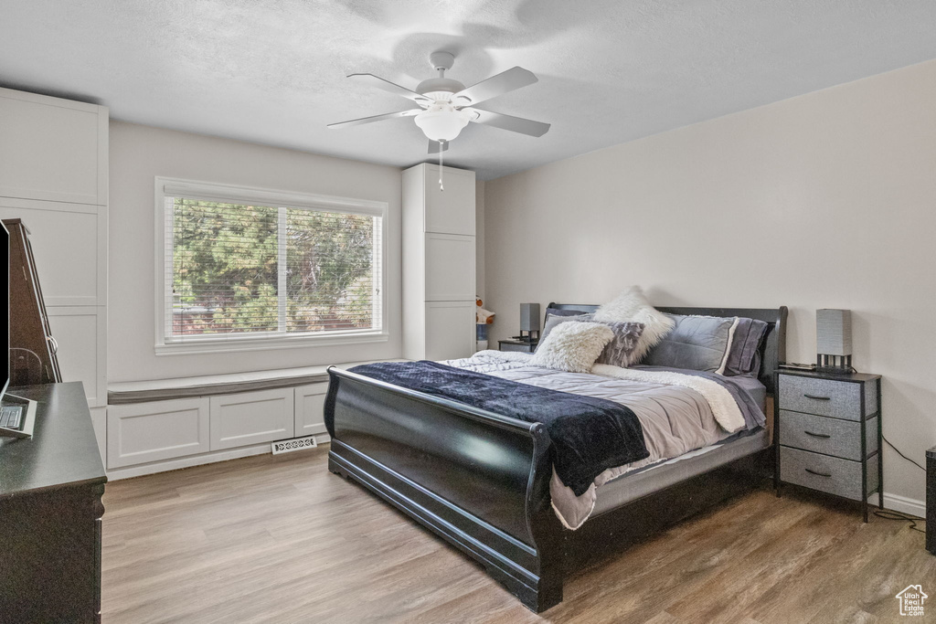Bedroom featuring light wood-style floors and a ceiling fan