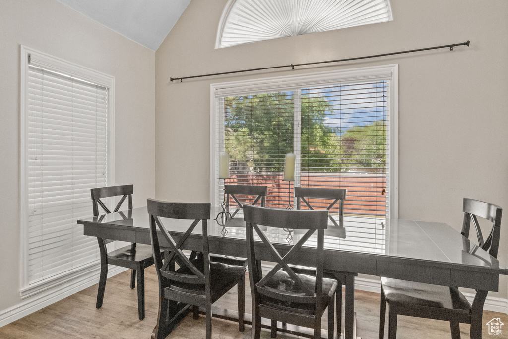 Dining area featuring wood finished floors and vaulted ceiling