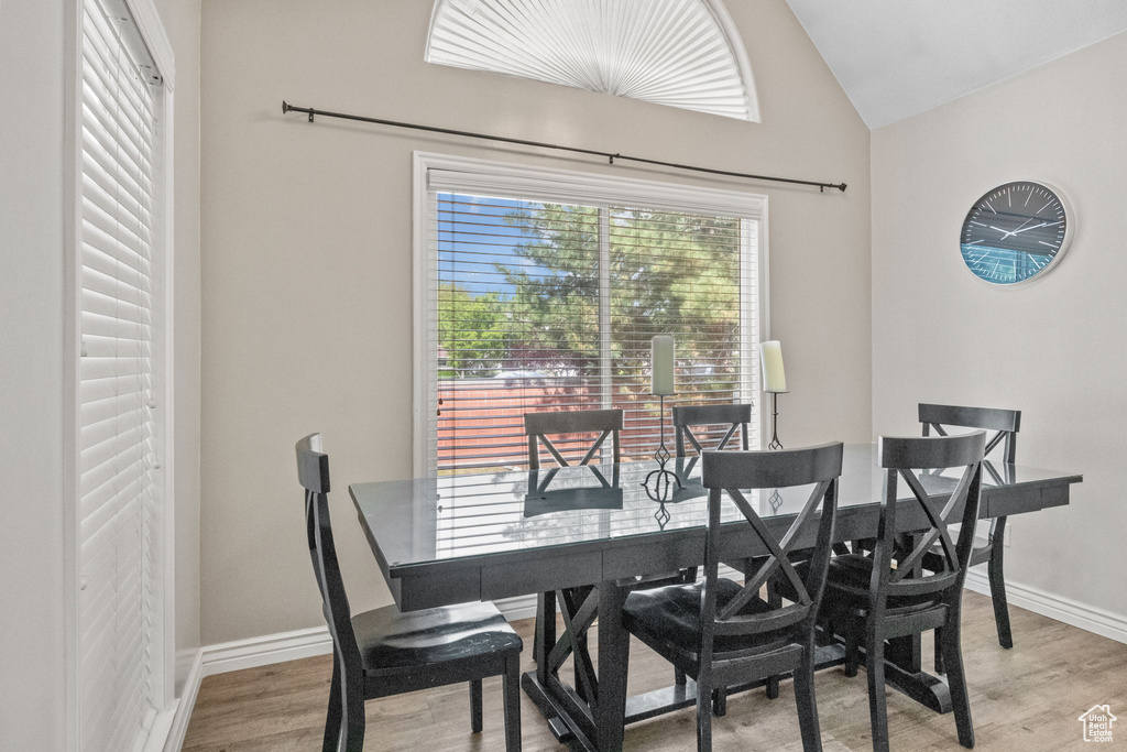 Dining space featuring lofted ceiling, light wood-type flooring, and baseboards