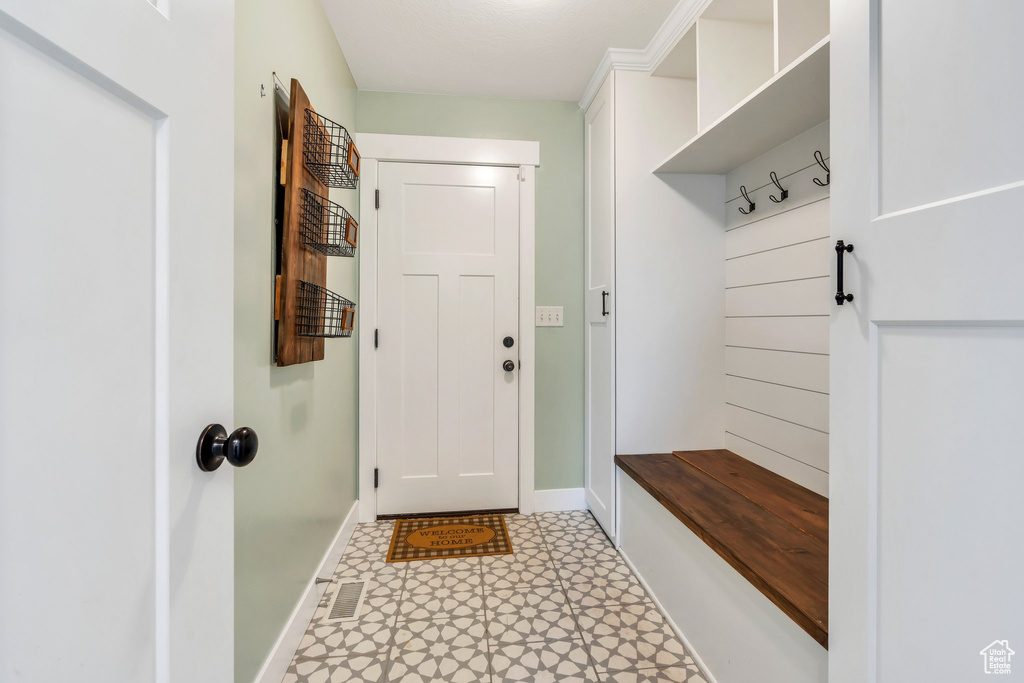 Mudroom featuring baseboards and light flooring