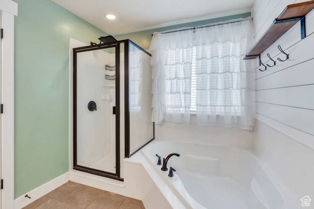 Bathroom with a stall shower, tile patterned floors, a bath, baseboards, and recessed lighting