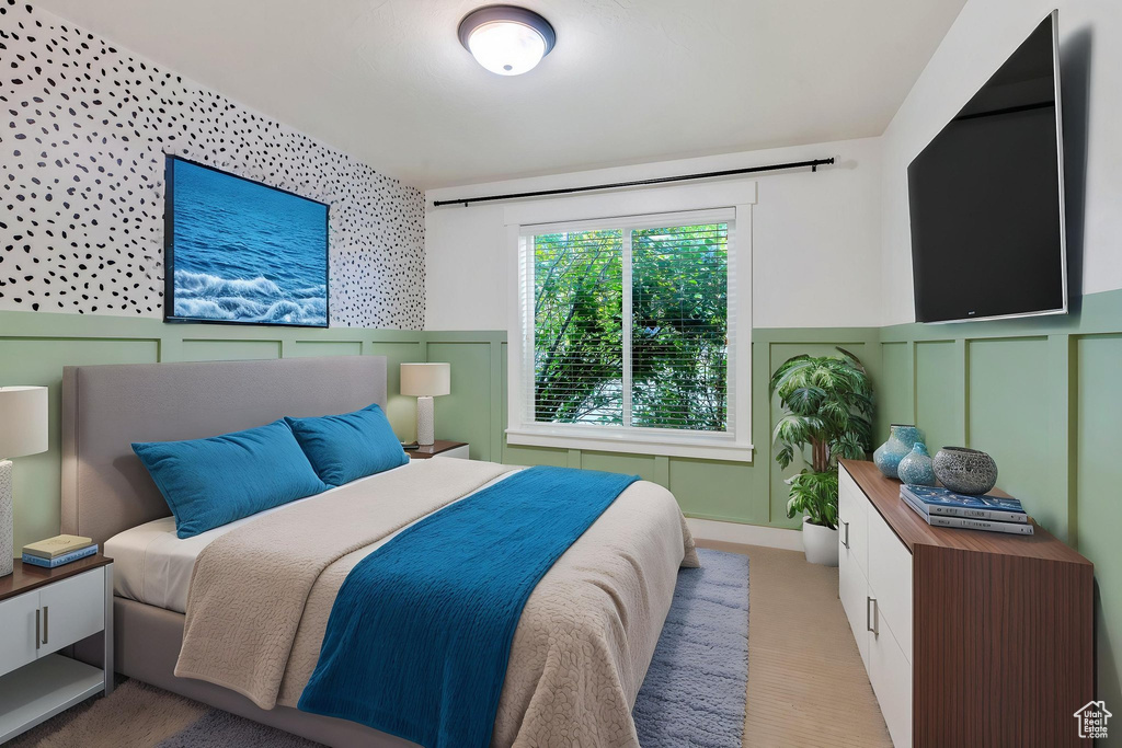 Bedroom with a decorative wall and a wainscoted wall