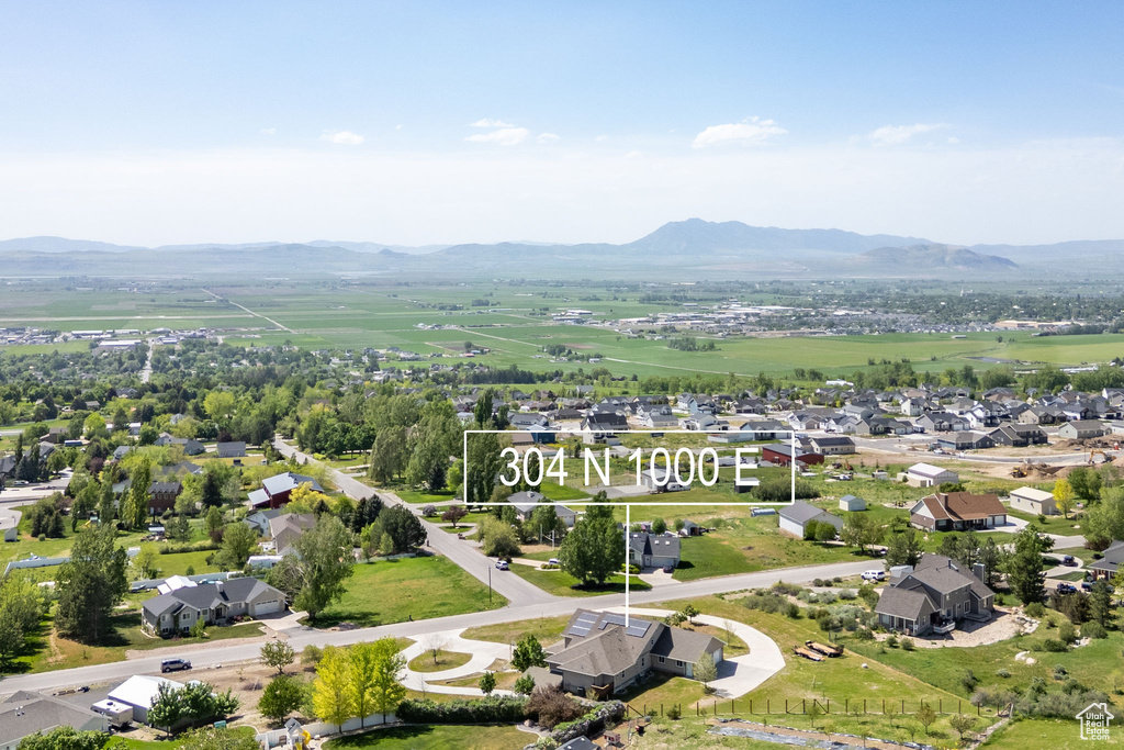 Aerial perspective of suburban area featuring a mountainous background