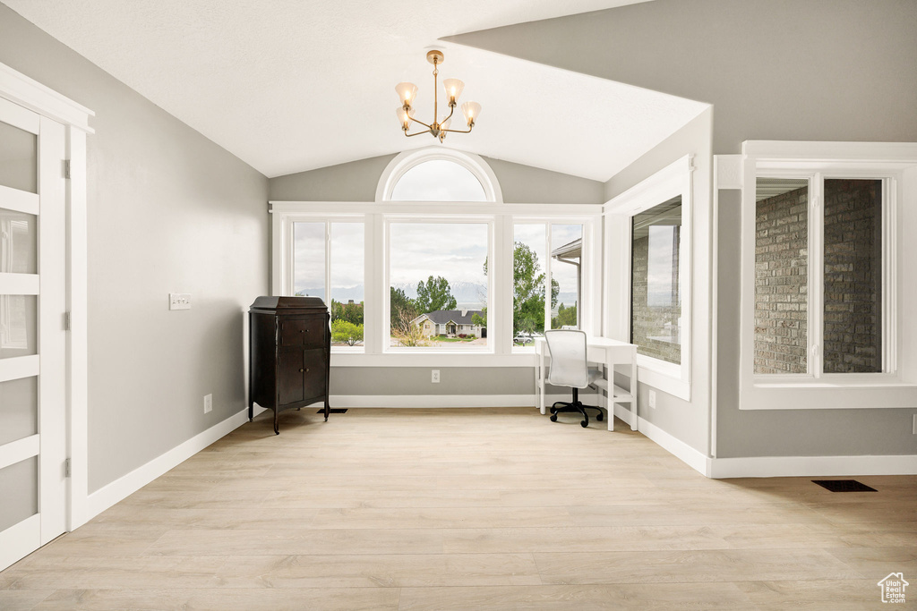 Sitting room featuring a chandelier, light wood-style flooring, vaulted ceiling, a desk, and baseboards