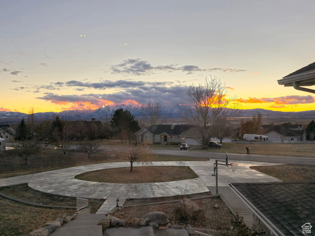 Yard at dusk featuring a mountain view