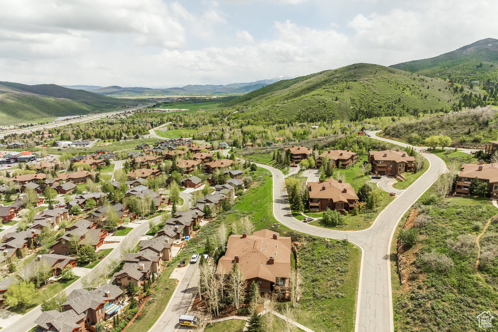 Aerial overview of property's location with mountains and nearby suburban area