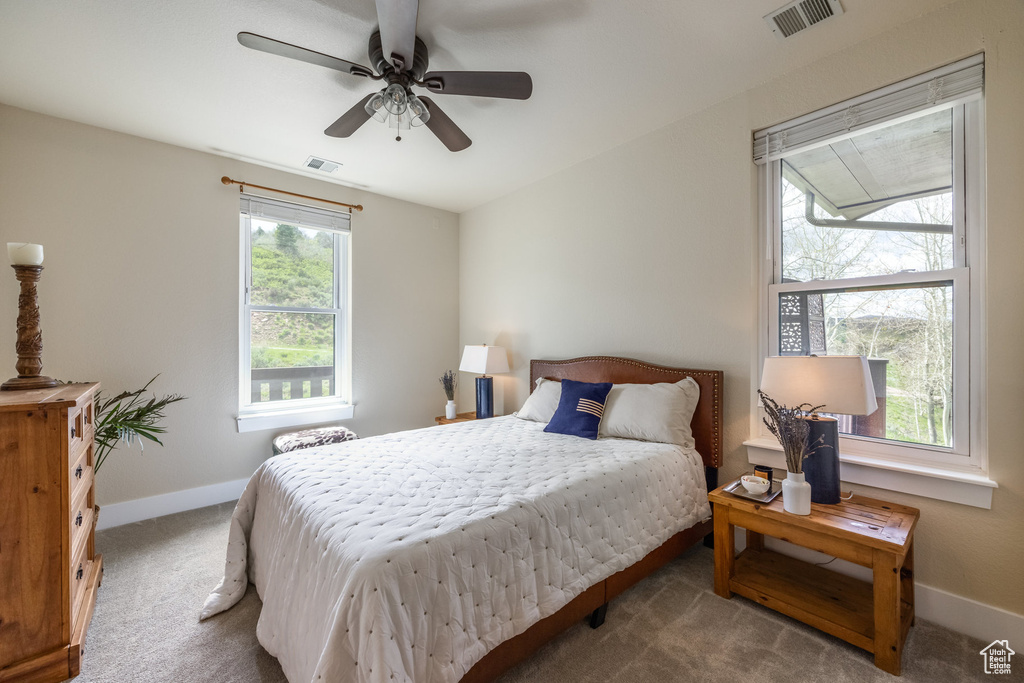 Bedroom featuring carpet, baseboards, and ceiling fan
