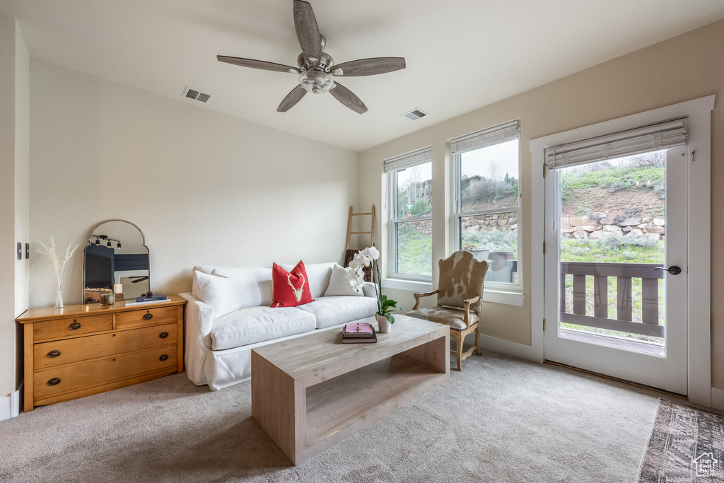 Living area with carpet floors, vaulted ceiling, and ceiling fan