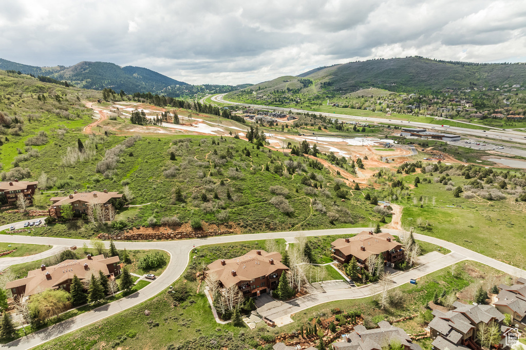 Aerial view of property and surrounding area with a mountainous background