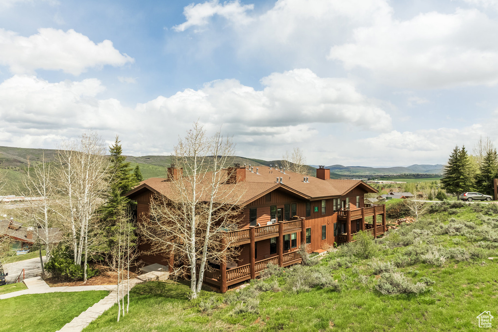 Rear view of house with a chimney and a deck