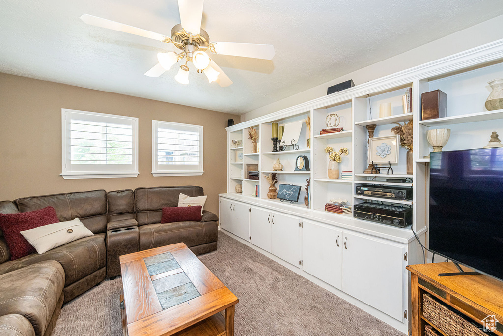 Living room with light carpet and a ceiling fan