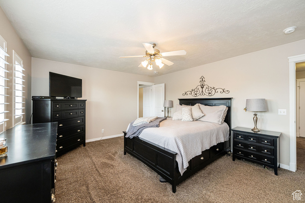 Bedroom featuring carpet, baseboards, and ceiling fan