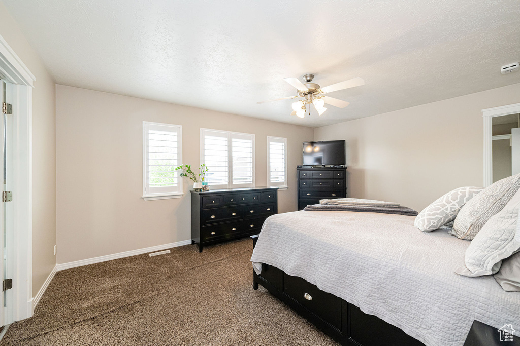 Bedroom featuring carpet, baseboards, and a ceiling fan