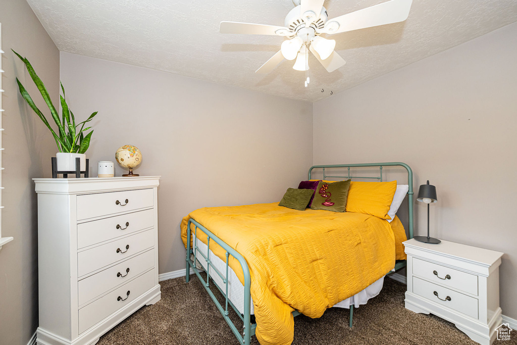 Bedroom with carpet floors, ceiling fan, and baseboards