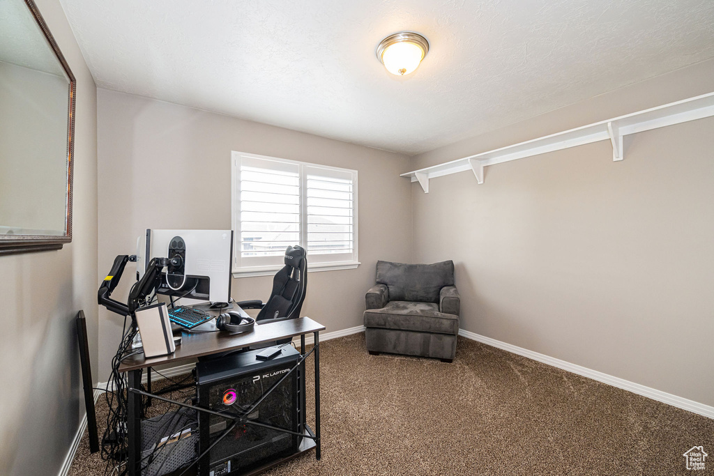 Carpeted office space featuring baseboards