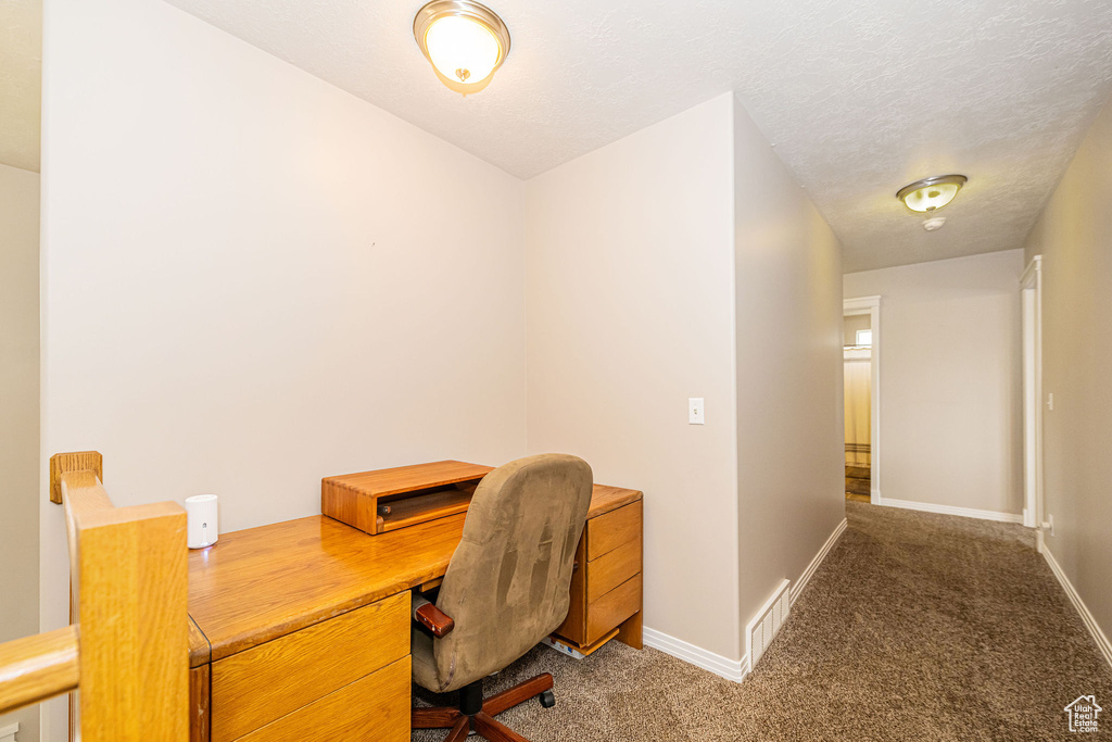 Carpeted office featuring baseboards