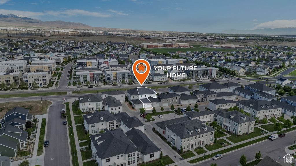 Aerial perspective of suburban area featuring a mountainous background