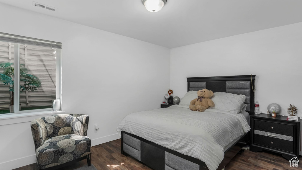 Bedroom featuring wood finished floors and baseboards