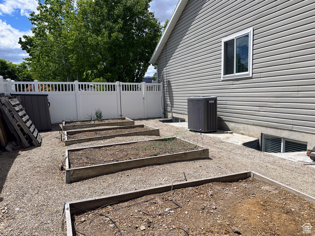 View of yard featuring central AC unit and a vegetable garden