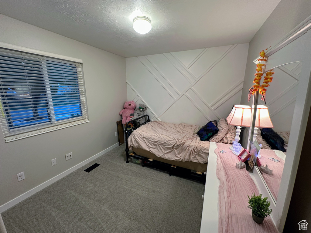 Carpeted bedroom featuring baseboards