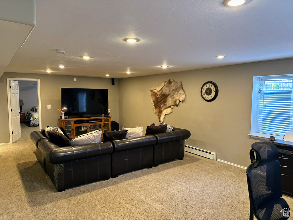 Living room with light carpet, a baseboard heating unit, recessed lighting, and baseboards