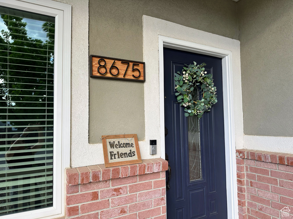Doorway to property featuring stucco siding