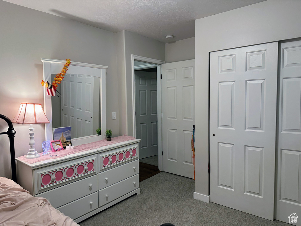 Bedroom with carpet floors and a closet