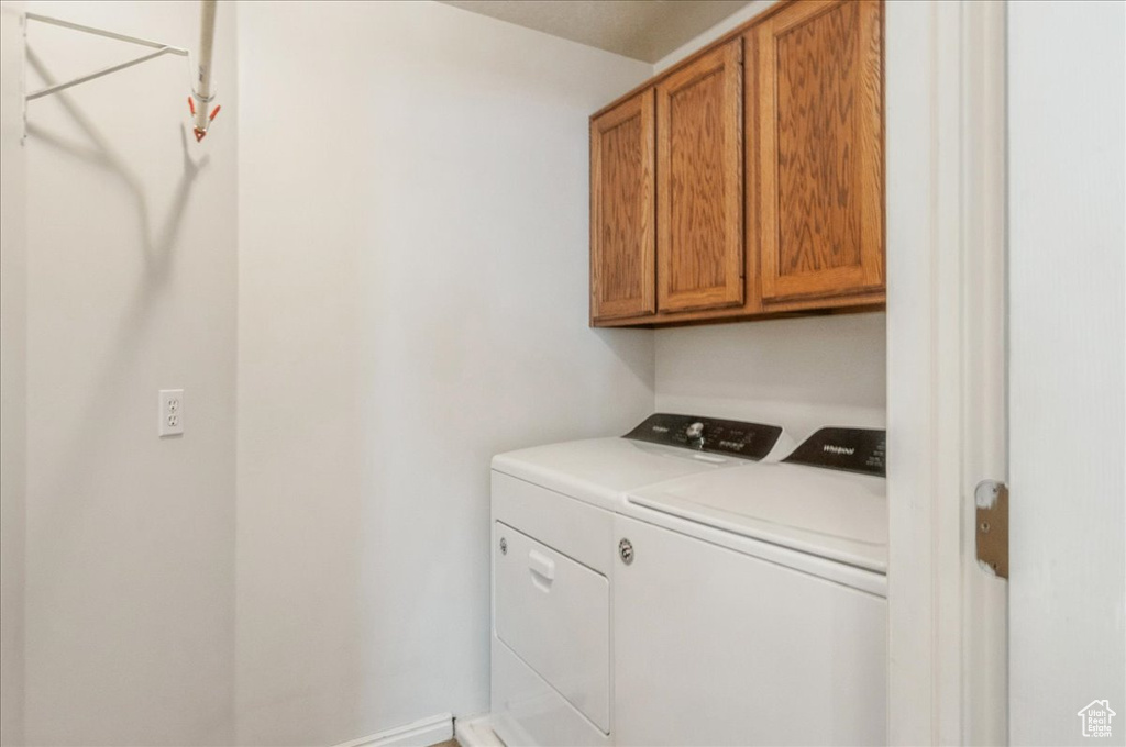 Laundry area featuring cabinet space and washing machine and clothes dryer