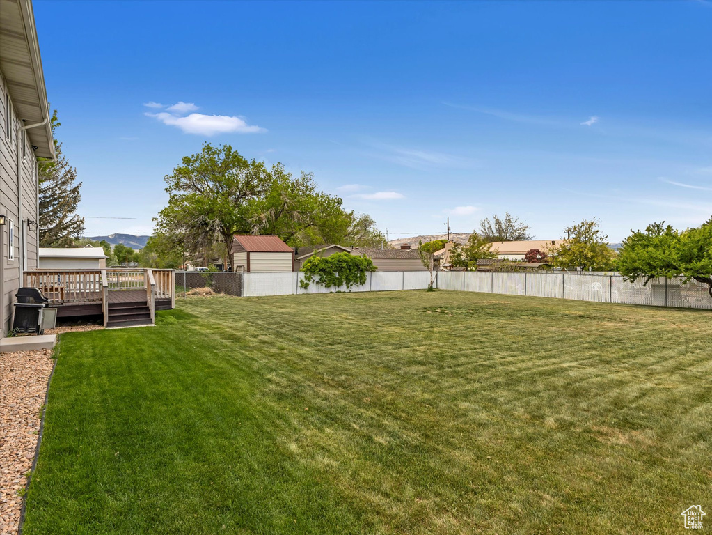View of yard featuring a deck with mountain view