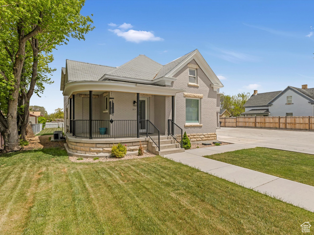 View of front of house with covered porch and brick siding