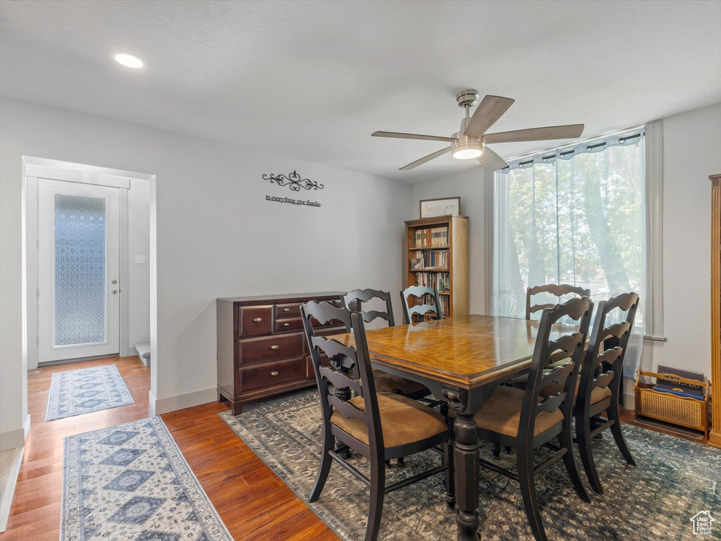 Dining space featuring ceiling fan, wood finished floors, recessed lighting, and baseboards