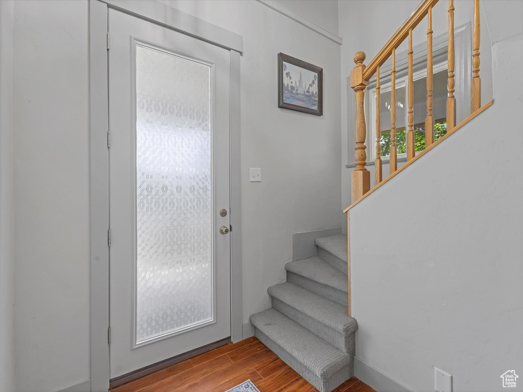 Entryway featuring wood finished floors and stairs