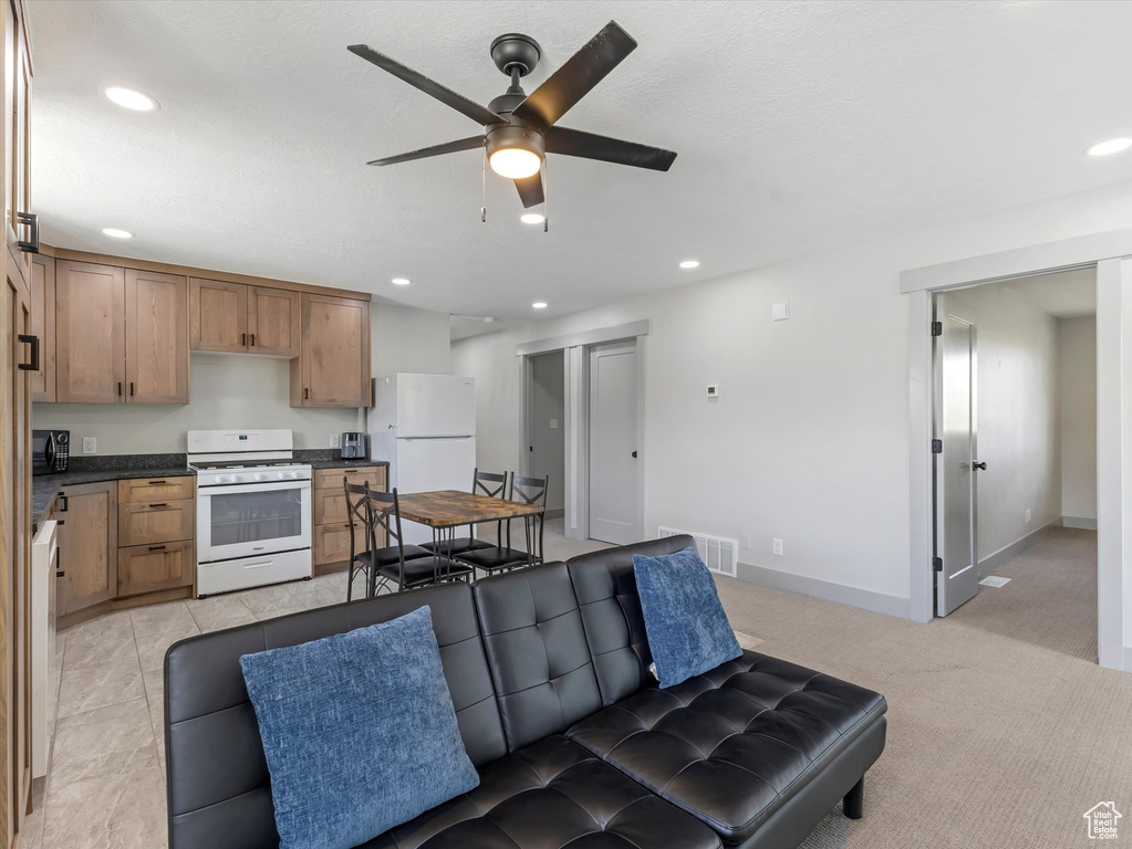 Living room with a ceiling fan, recessed lighting, and baseboards