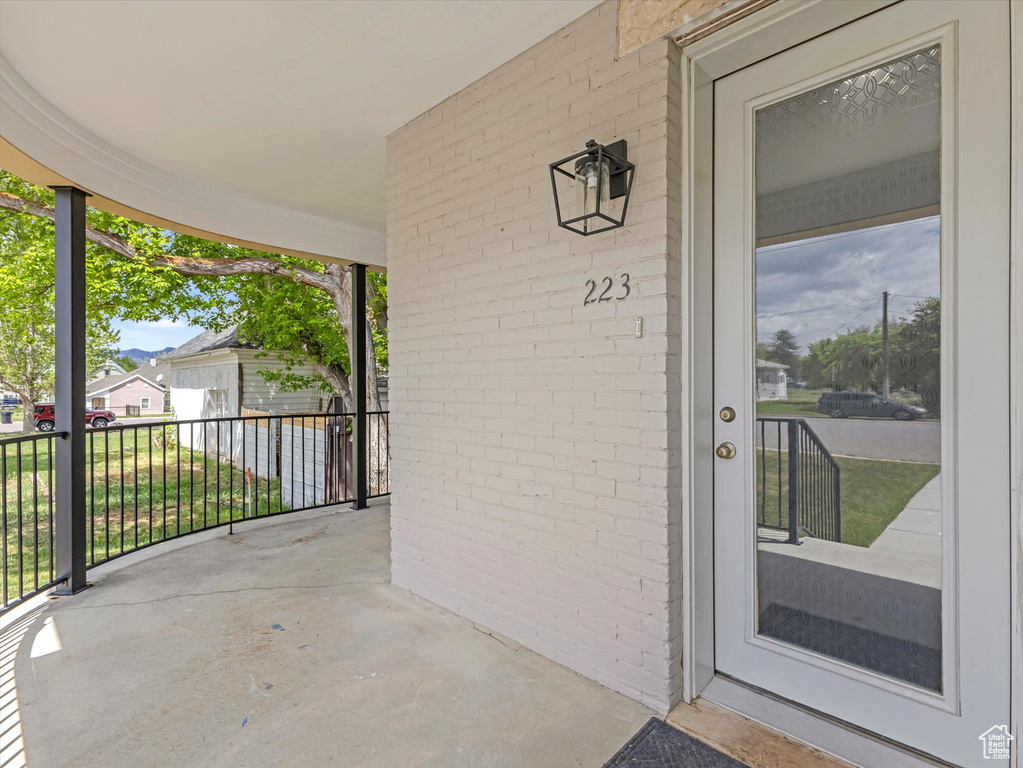 Doorway to property featuring brick siding