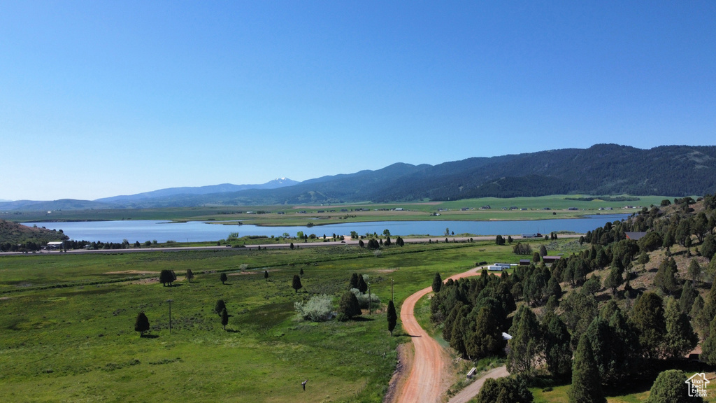 View of mountain backdrop featuring a large body of water and rural landscape