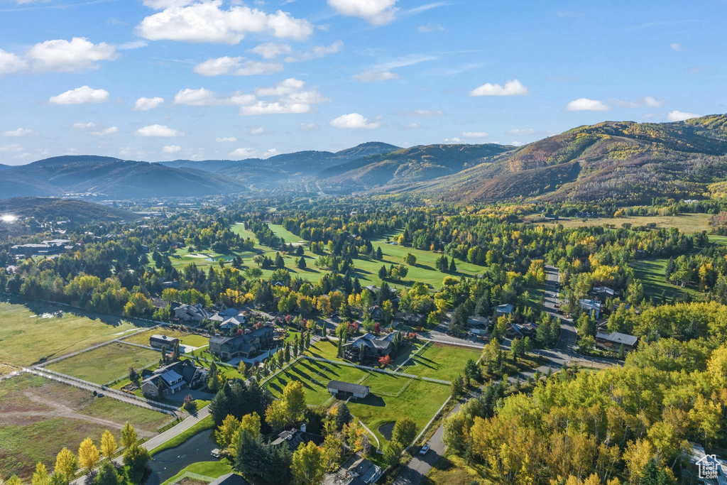Aerial view of property and surrounding area with mountains