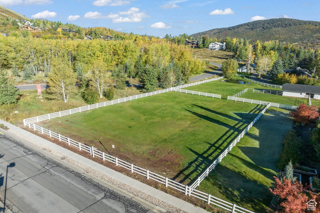 Aerial view of sparsely populated area featuring a mountain backdrop and agricultural land