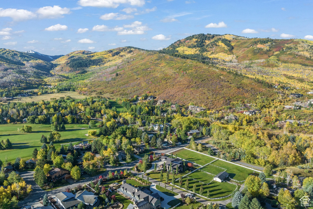 Aerial view of property and surrounding area featuring mountains