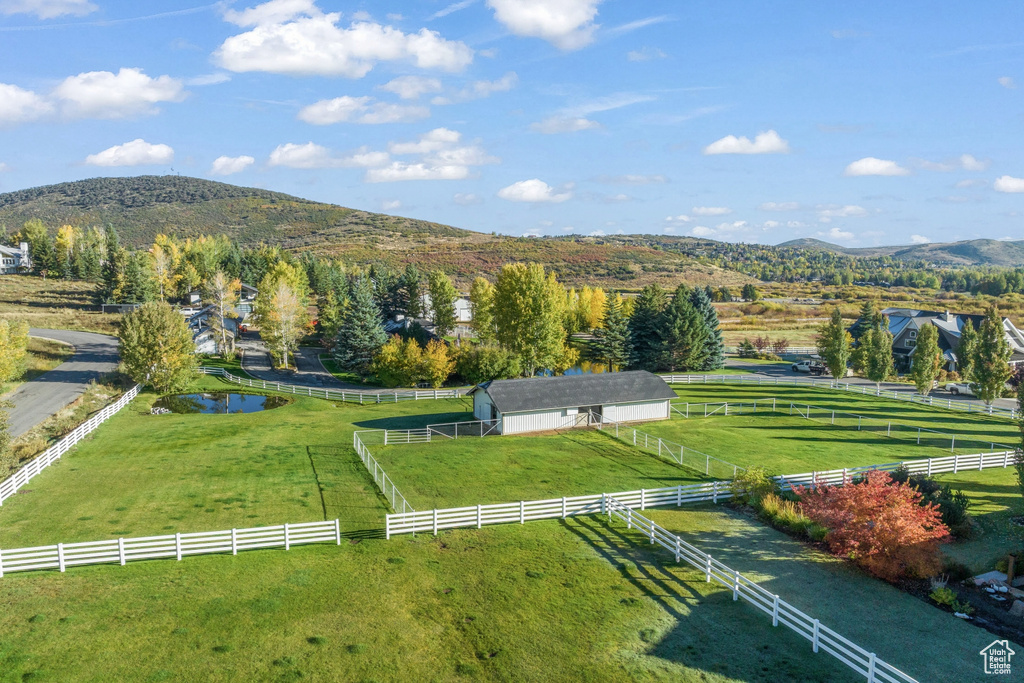 View of property's community with a mountain view, a view of rural / pastoral area, and an outdoor structure