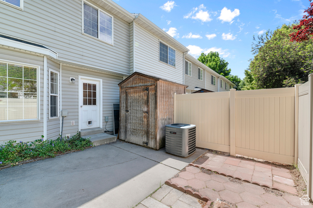 Rear view of house with central AC, a patio area, and entry steps